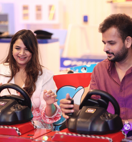 Parents enjoying an exciting car racing ride together at Wooray Hyderabad.