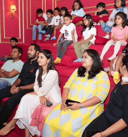 Families and children enjoying a movie together in the theatre at Wooray Hyderabad.